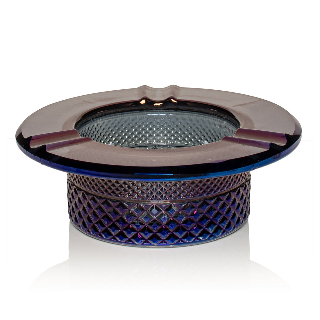 Glass ashtray with decorative design on a white background