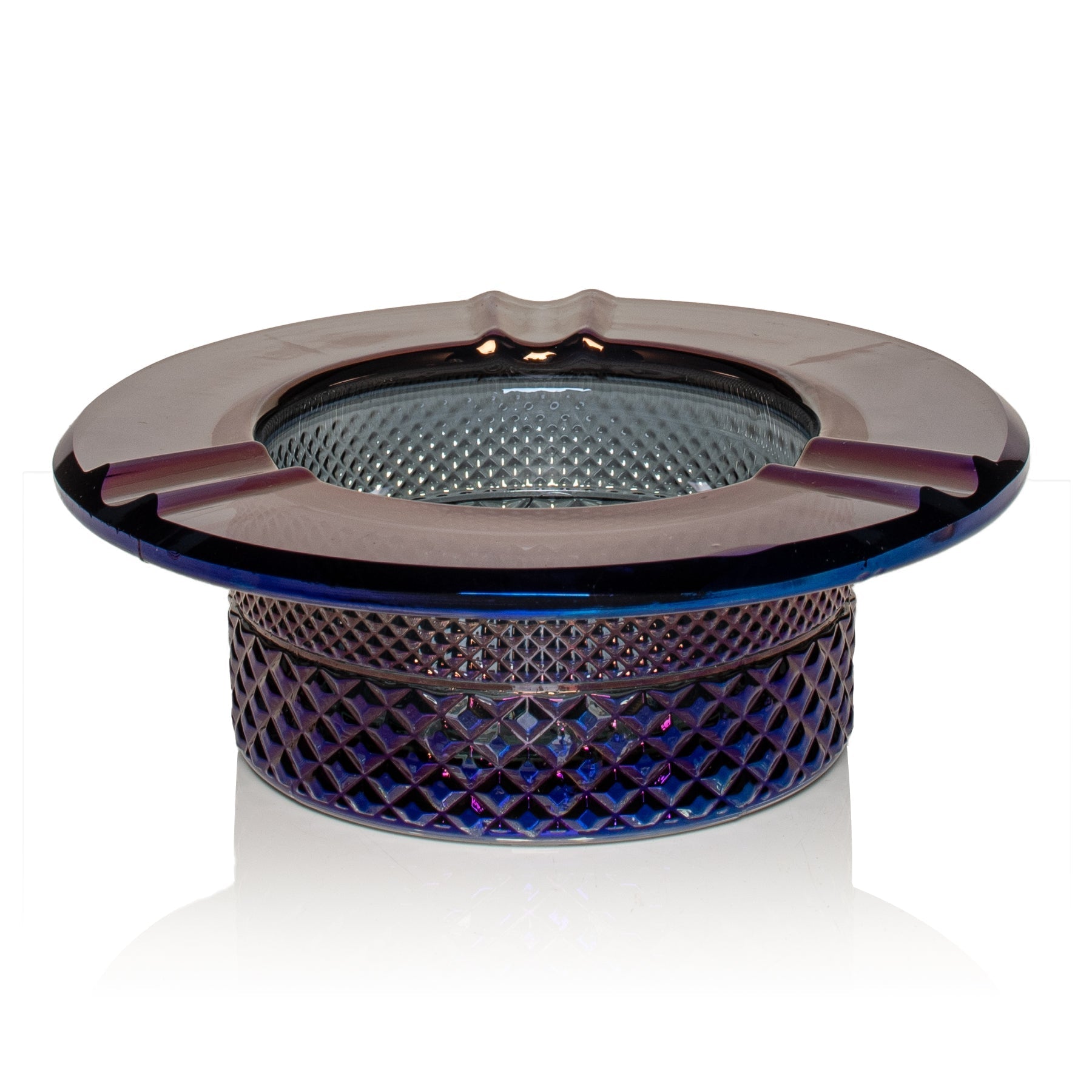 Glass ashtray with decorative design on a white background