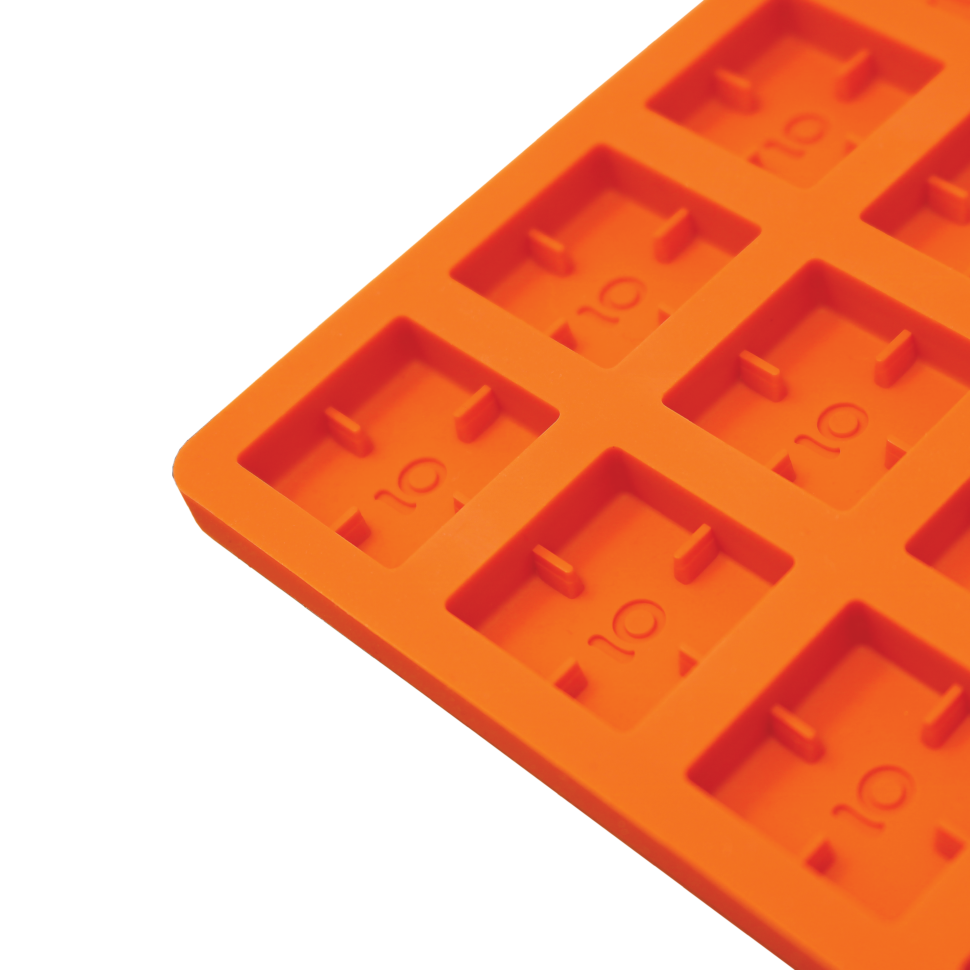 Orange silicone mold with multiple compartments on a white background