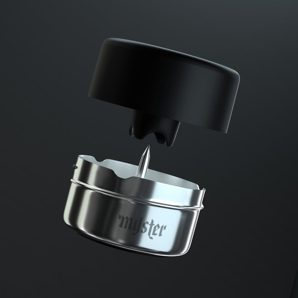 Metallic container with a black lid on a dark background