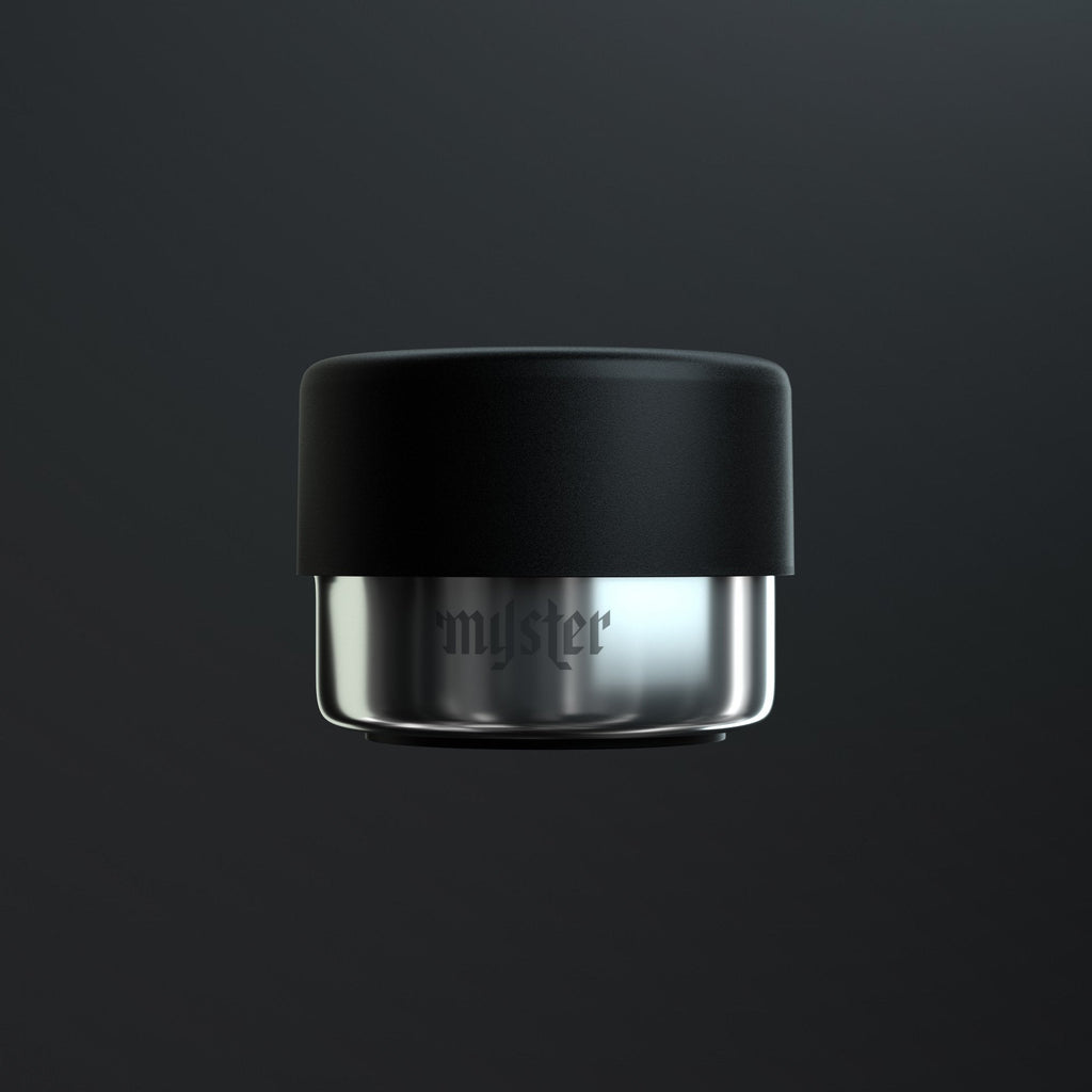 Black and silver ashtray with 'myster' branding on a dark background