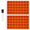 Two orange silicone molded trays on a white background